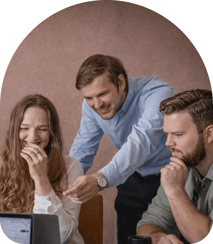 Team collaborating around a laptop